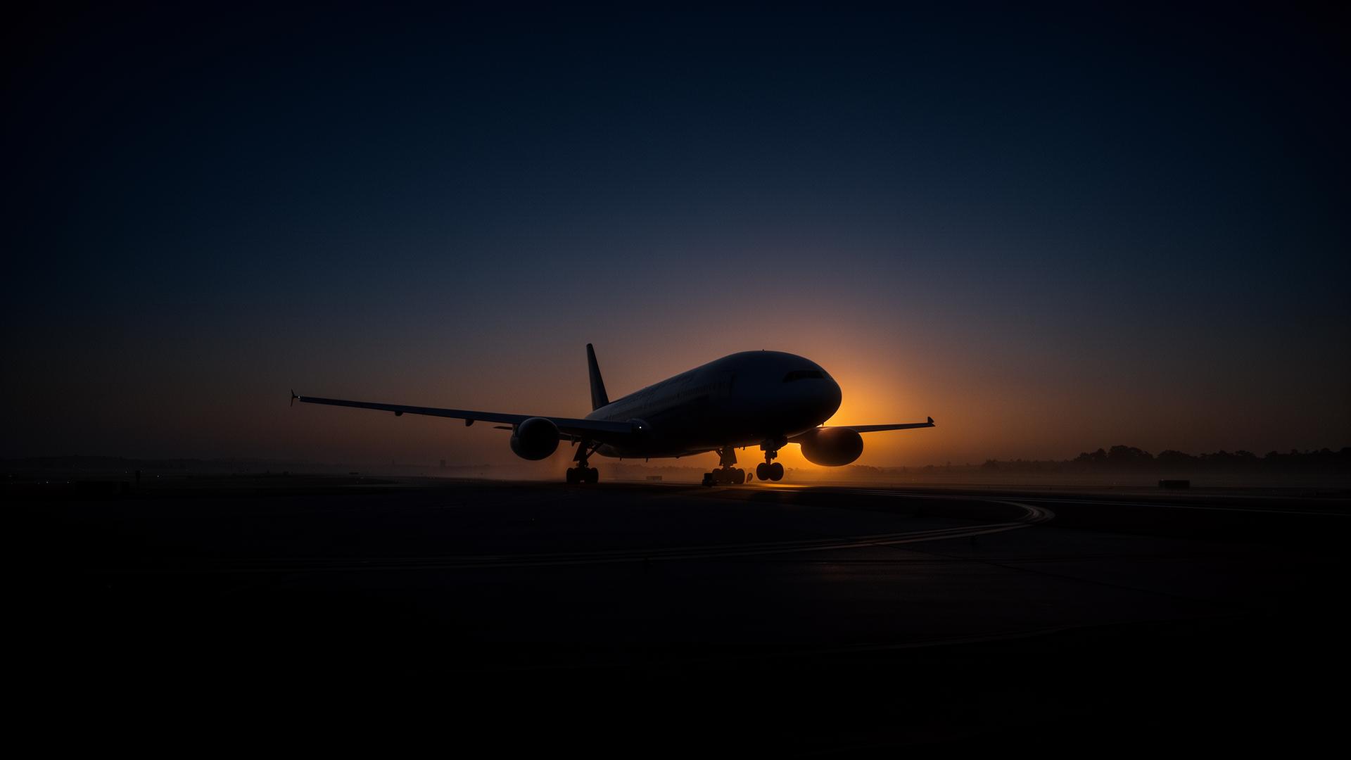 Airliner on runway at sunrise